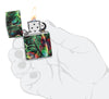 Zippo Psychedelic Swirl Design Glow in the Dark Green Matte Windproof Lighter lit in hand.