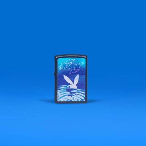 Lifestyle image of Zippo Playboy Navy Matte Windproof Lighter standing in a blue scene.