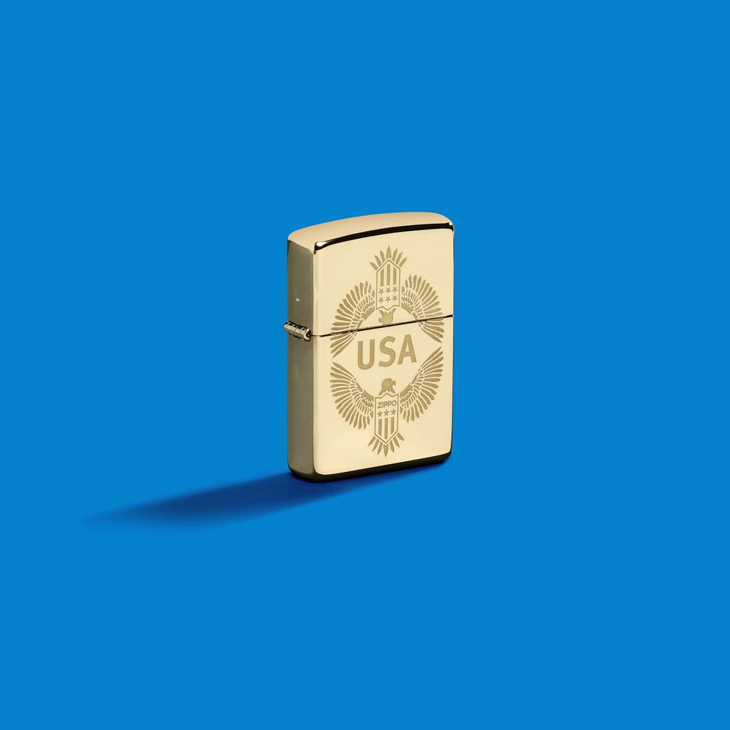 Lifestyle image of Zippo USA High Polish Brass Windproof Lighter on a blue background.