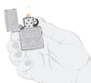 Zippo Flame Design Armor High Polish Chrome Windproof Lighter lit in hand.