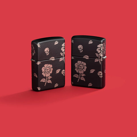 Lifestyle image of two Zippo Flower Skulls Design Black Matte with Chrome Windproof Lighters on a red background.