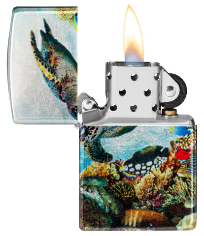 Zippo Deep Sea Design 540 Tumbled Chrome Windproof Lighter with its lid open and lit.