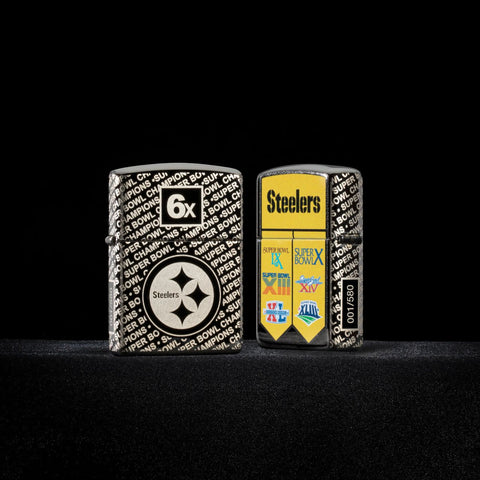 Lifestyle image of two Zippo NFL Pittsburgh Steelers Super Bowl Commemorative Armor Black Ice Windproof Lighters with a black background.
