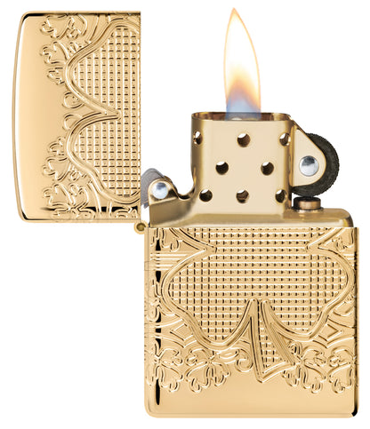 Zippo Lucky Clover Design ArmorÂ® High Polish Gold Plate Windproof Lighter with its lid open and lit.