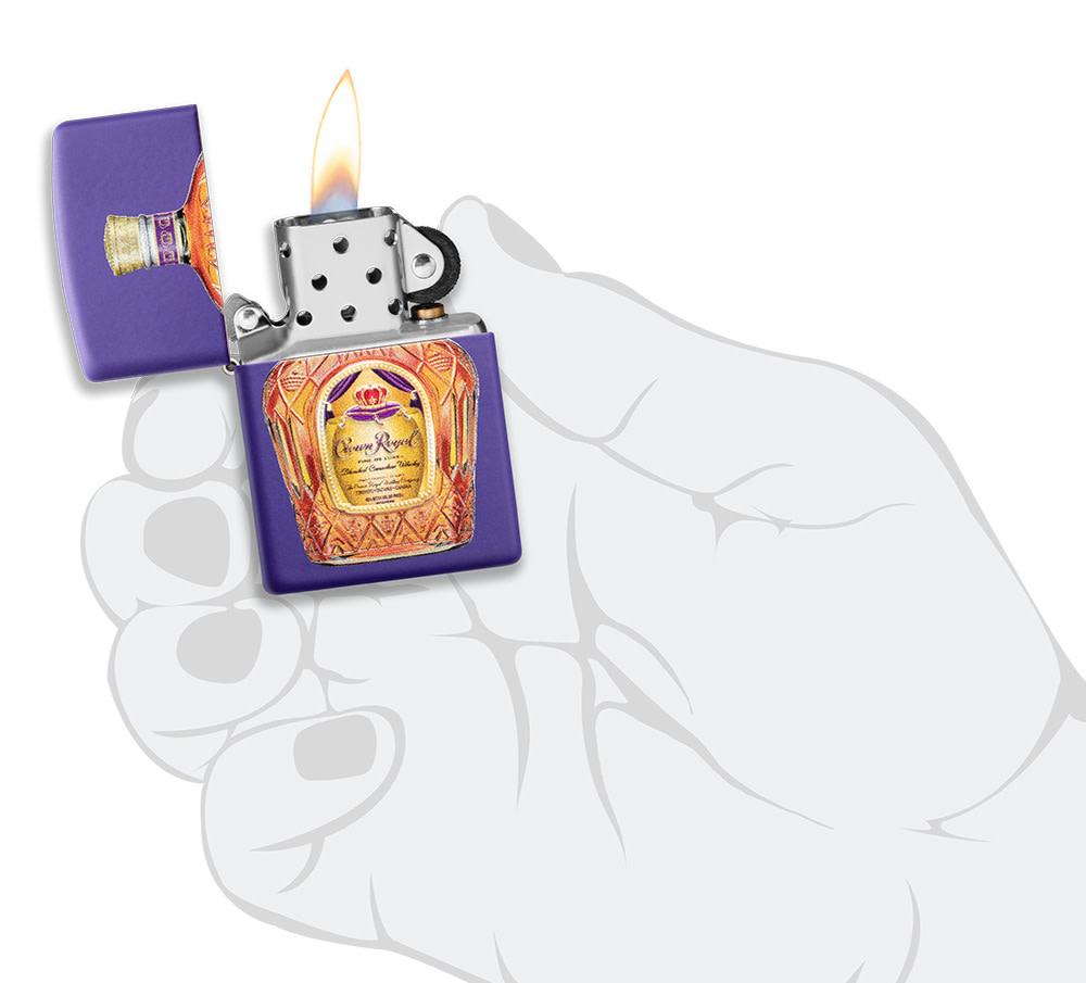 Crown Royal® Purple Matte Windproof Lighter lit in hand.