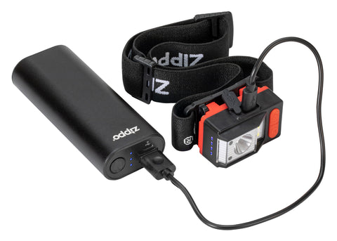 Image of the Zippo Headlamp being charged by the Zippo Black HeatBank® 6 Rechargeable Hand Warmer with the included USC chord.