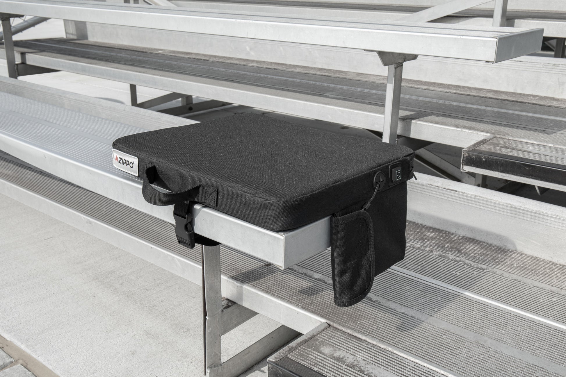 Bottom view of Zippo Heated Seat - Single showing the bottom side of the seat sitting on a bleacher.