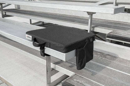 Bottom view of Zippo Heated Seat - Single showing the bottom side of the seat sitting on a bleacher.