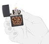 Three Monkeys Black Matte Windproof Lighter lit in hand.