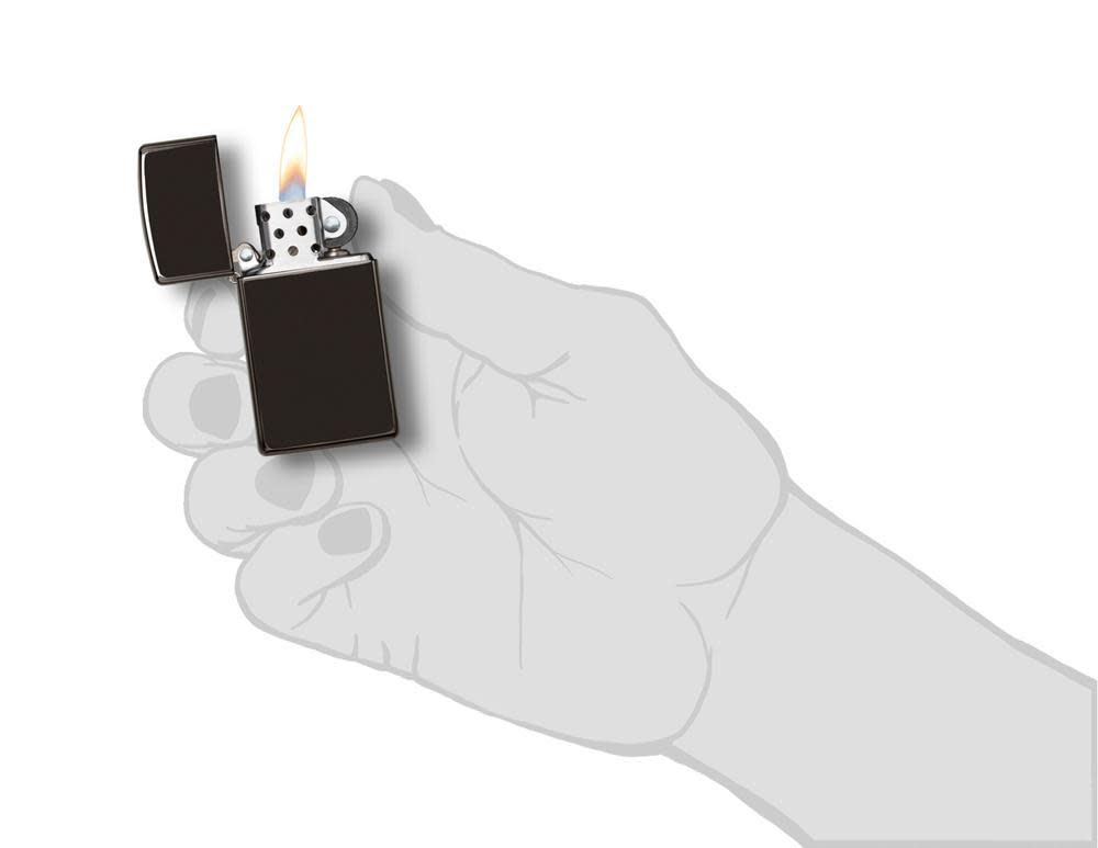 SlimÂ® High Polish Black Windproof Lighter lit in hand.