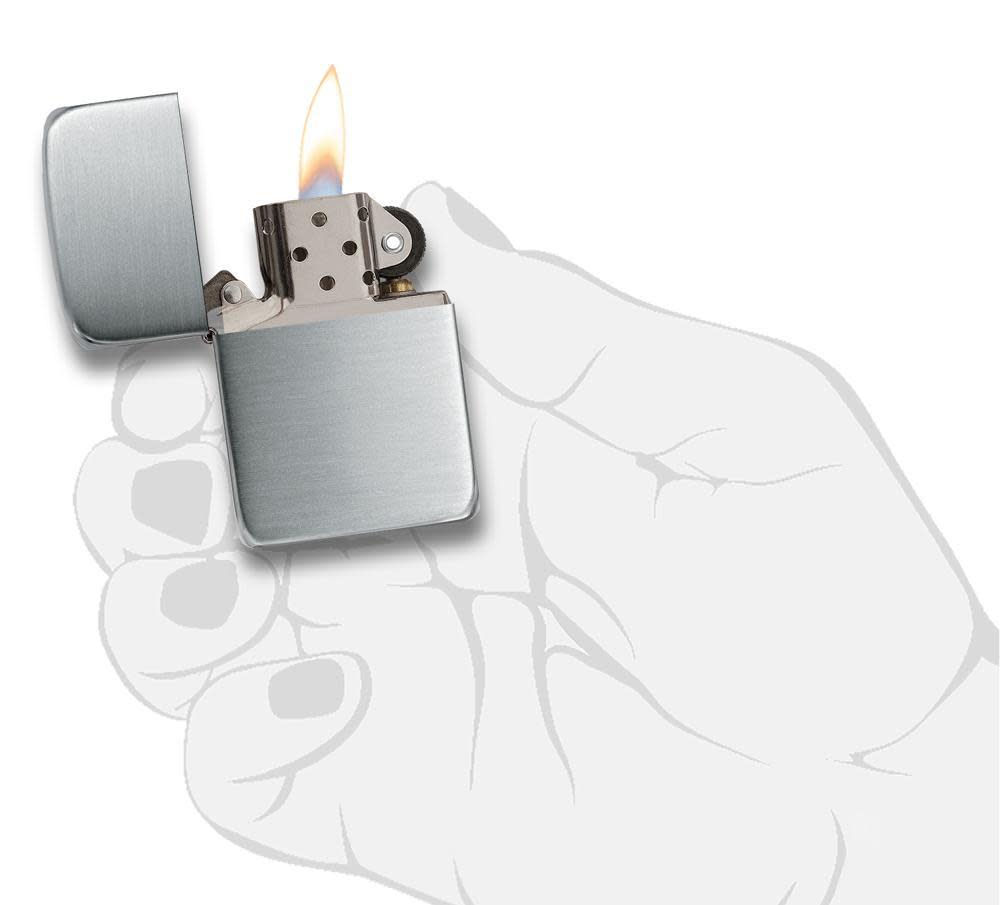 Front view of the Hand Satin Sterling Silver 1941 Replica Lighter in hand, open and lit