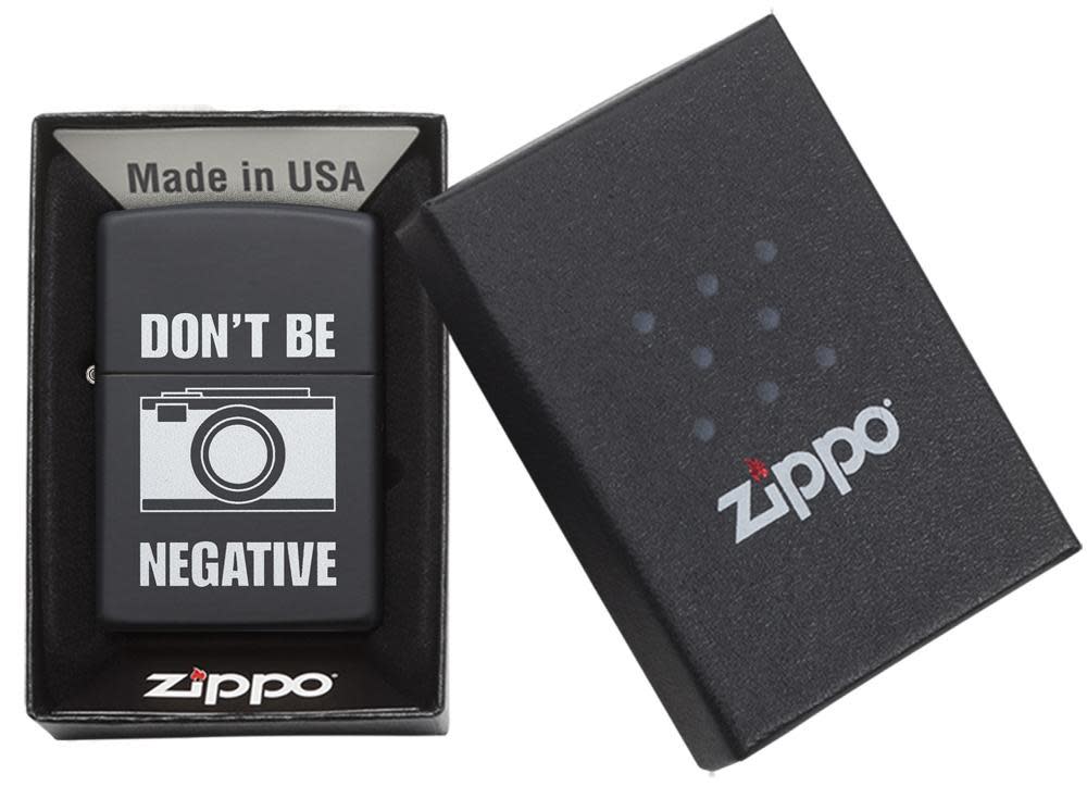 Front view of the Don't Be Negative Black Matte Windproof Lighter in one box packaging 