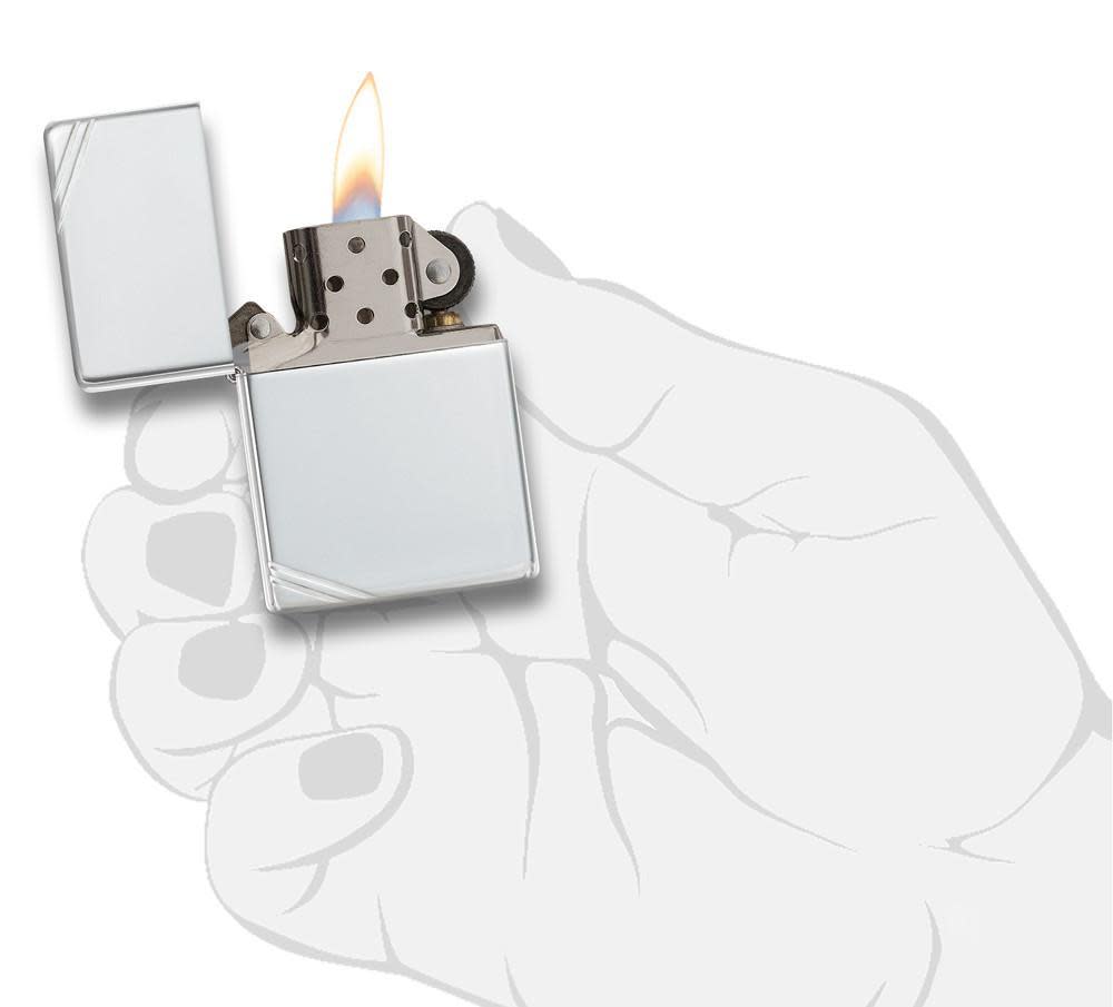 Sterling Silver Vintage with Slashes Windproof Lighter lit in hand