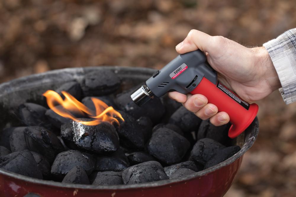 Lifestyle image of FireFast™ Torch lighting a charcoal grill
