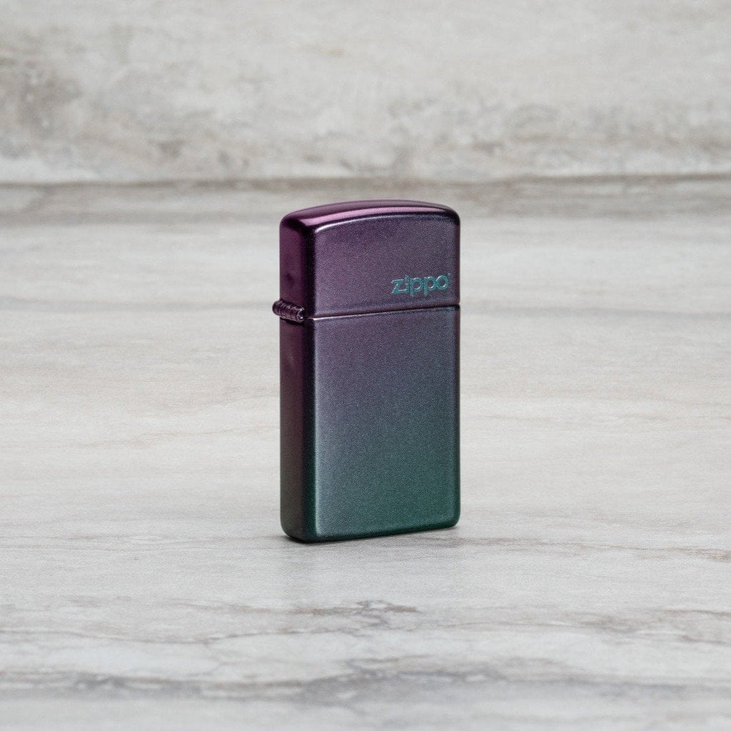 Lifestyle image of Slim® Iridescent Zippo Logo Windproof Lighter standing at an angle on a marble surface