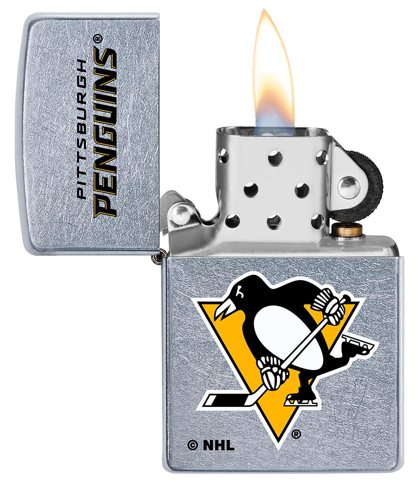 ©NHL Pittsburgh Penguins Street Chrome™ Windproof Lighter with its lid open and lit