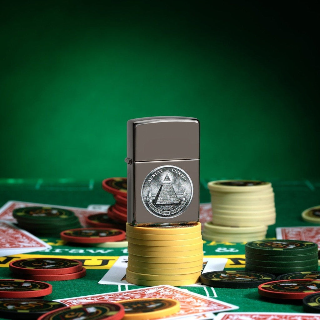 Dollar Design Black Ice® Windproof Lighter standing on stacked poker chips, with cards and chips scattered all around a poker table.