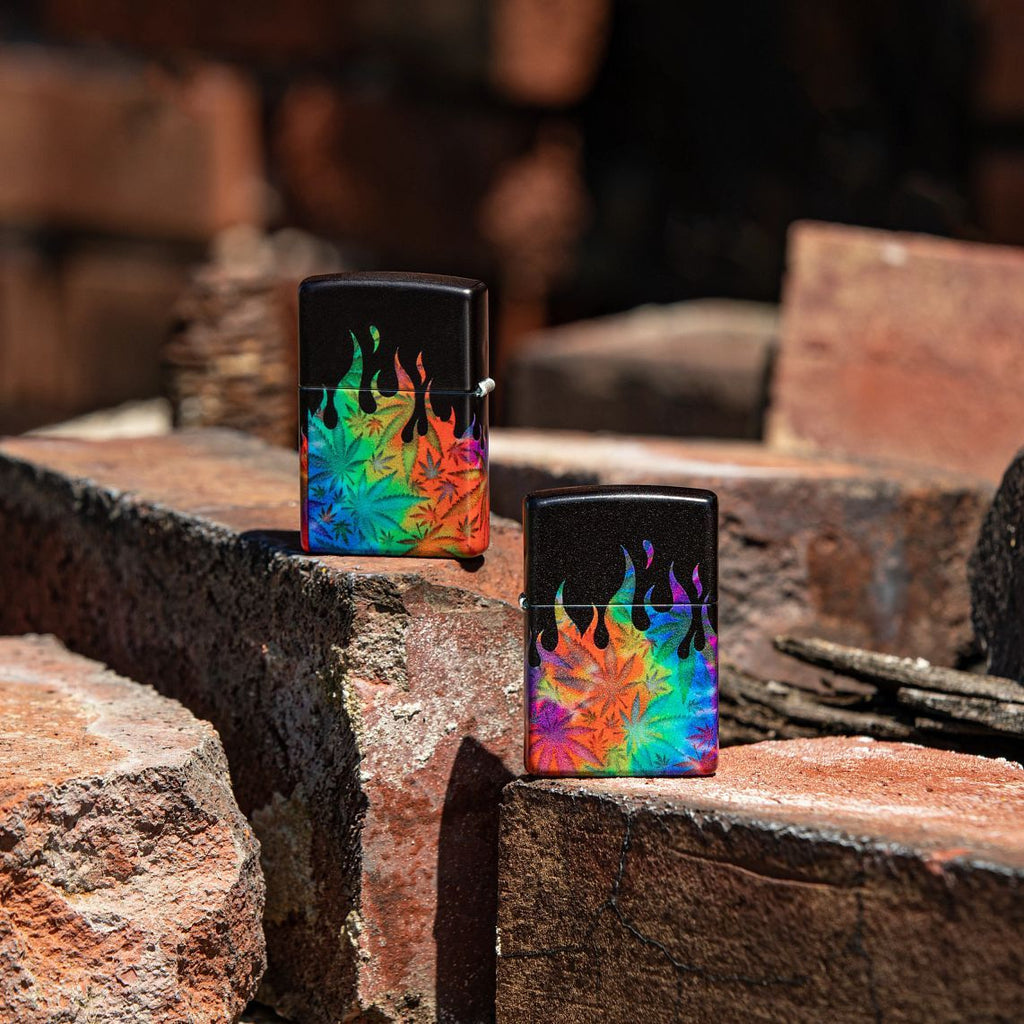 Lifestyle image of two Leaf Flame Multi Color Design 540 Color Windproof Lighters, with one lighter showing the front and the other showing the back