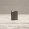 Lifestyle image of Classic Rustic Bronze Zippo Logo Windproof Lighter standing on a countertop.