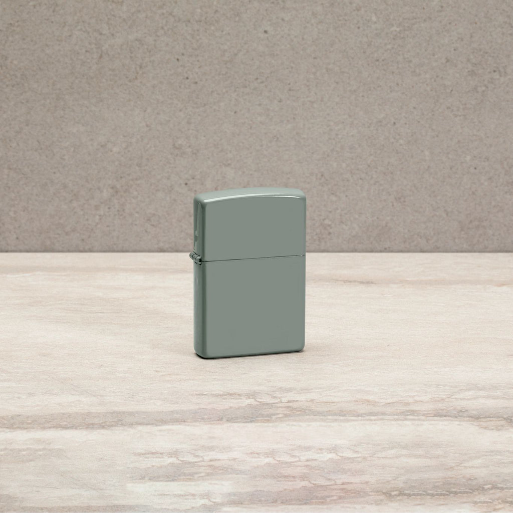 Lifestyle image of Classic Sage Windproof Lighter standing on a countertop.