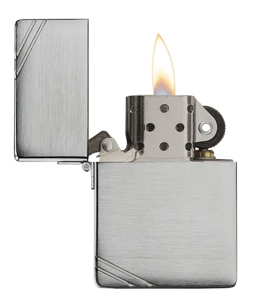 Brushed Chrome 1935 Replica Windproof Lighter with Slashes with its lid open and lit