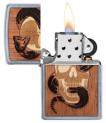 WOODCHUCK USA Skull & Snake Windproof Lighter with its lid open and lit, in hand