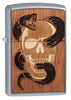 Front view of WOODCHUCK USA Skull & Snake Windproof Lighter standing at a 3/4 angle