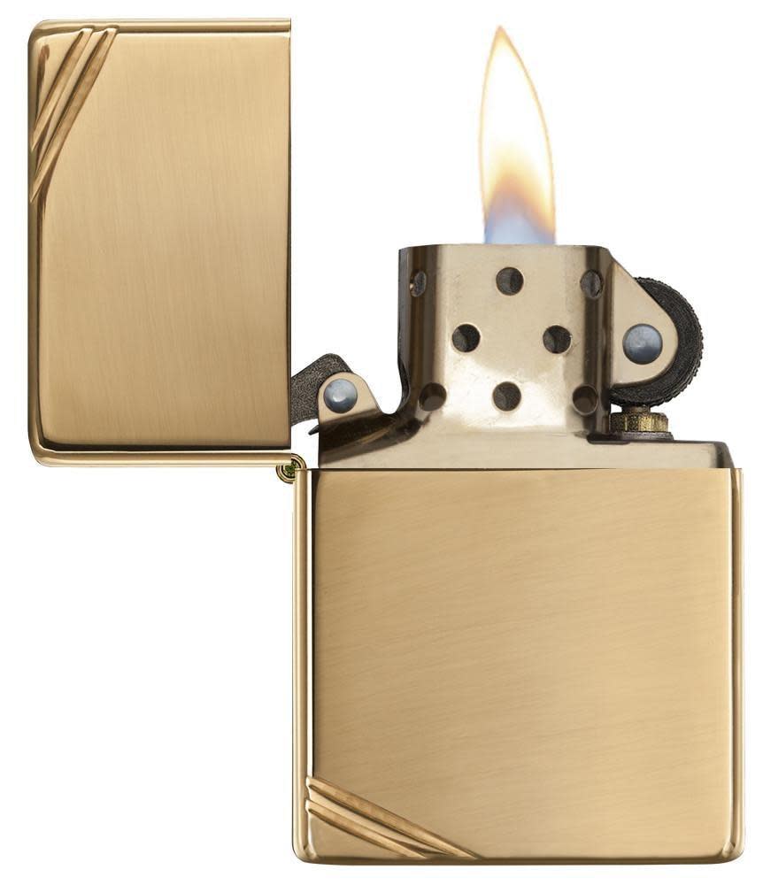 High Polish Brass Vintage with Slashes Windproof Lighter with its lid open and lit