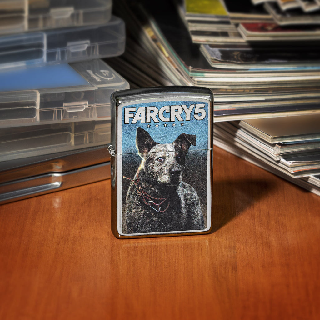 Front of Far Cry 5 Boomer lighter standing on a wooden desk with video games and magazines
