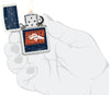 NFL Draft Denver Broncos Windproof Lighter lit in hand.