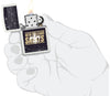 NFL Draft New Orleans Saints Windproof Lighter lit in hand.