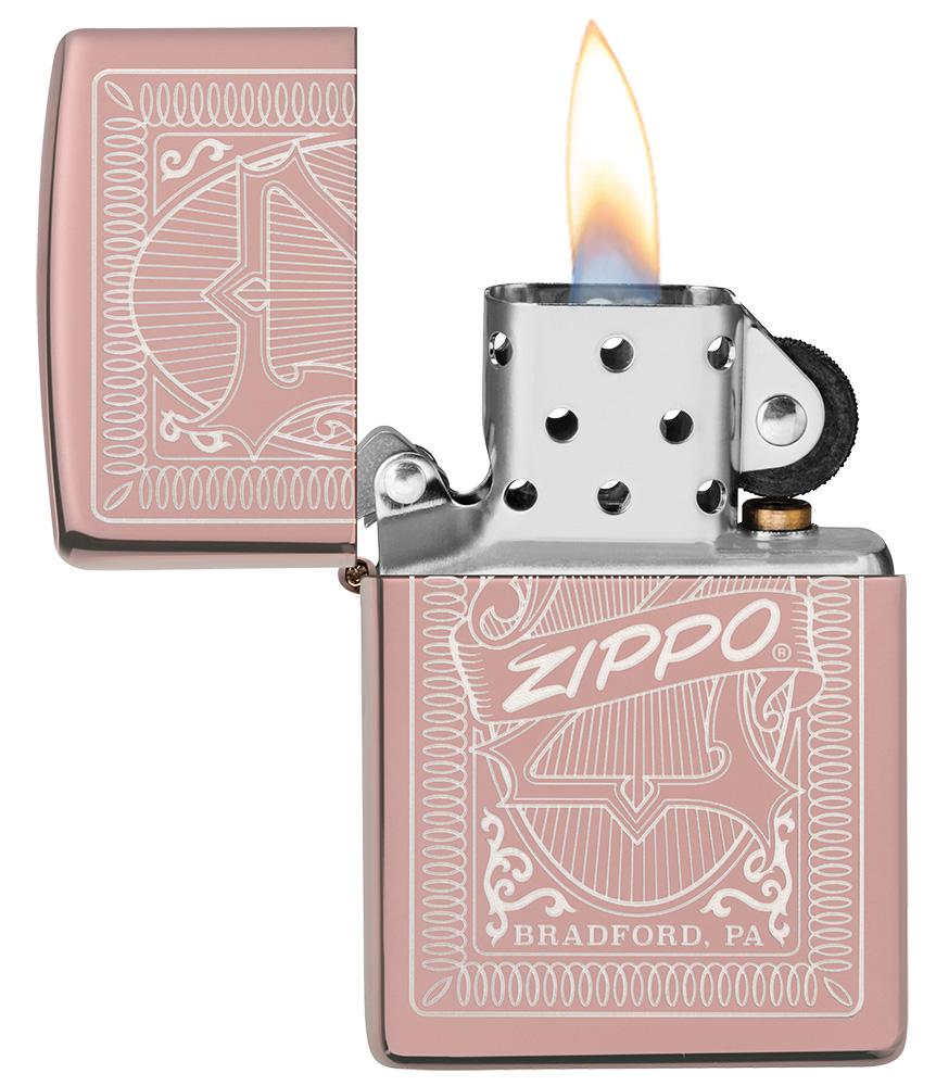 Reimagine Zippo High Polish Rose Gold Windproof Lighter with its lid open and lit