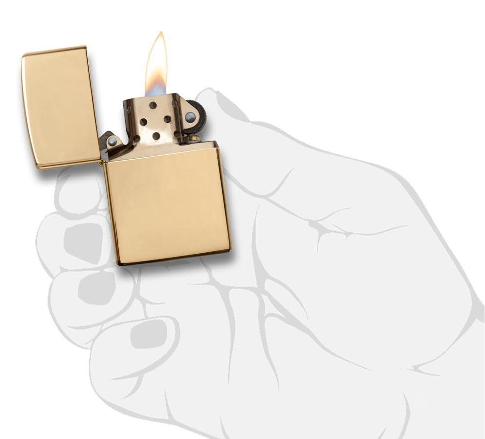 ArmorÂ® High Polish Brass Windproof Lighter lit in hand