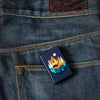 Lifestyle shot of the Geometric Bear and Mountains Design Lighter laying on a denim background