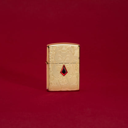 Lifestyle image of Lucky Cat Design Emblem Attached ArmorÂ® High Polish Brass Windproof Lighter standing in a red scene.