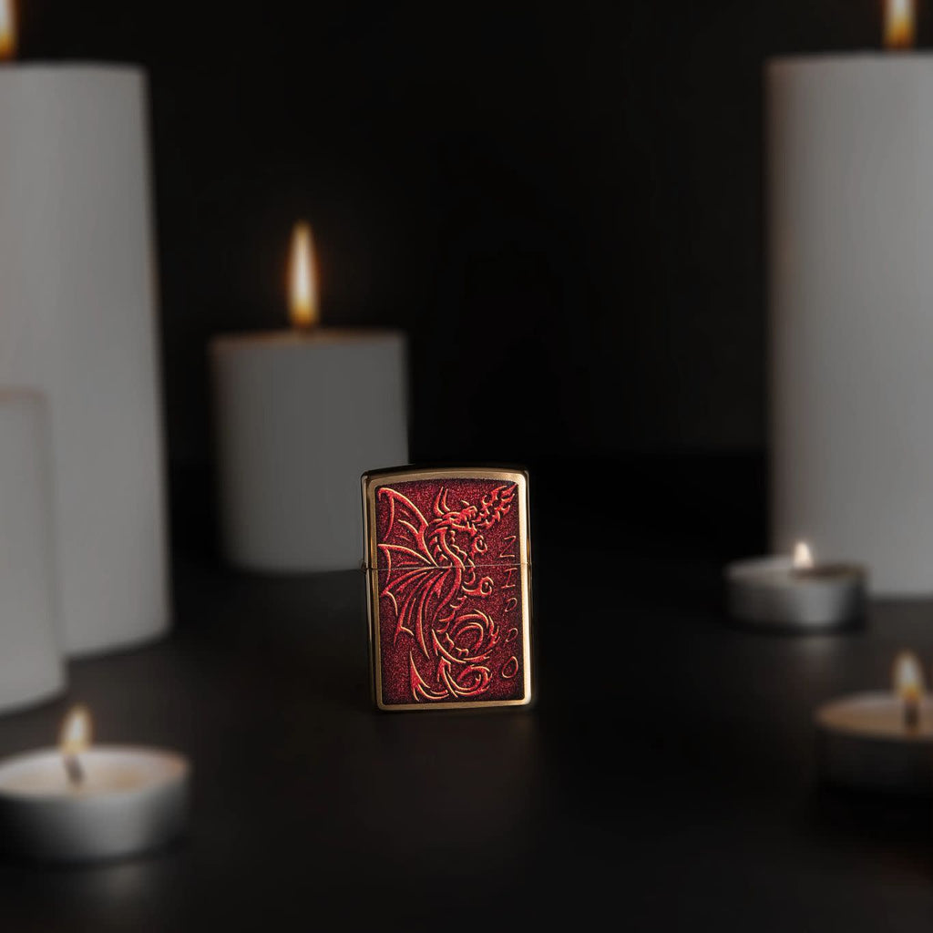 Lifestyle image of Medieval Mythological Dragon Brushed Brass Windproof Lighter standing with lit candles.