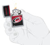 NHL® Carolina Hurricanes Street Chrome™ Windproof Lighter lit in hand