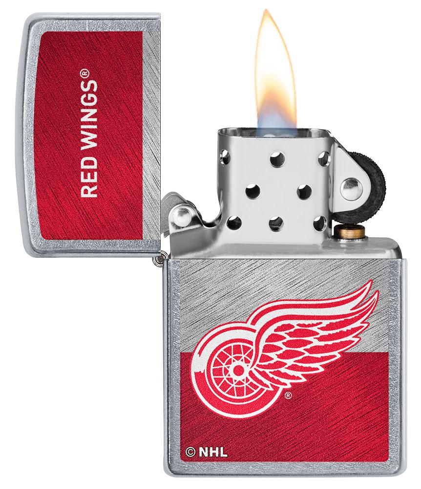 NHL® Detroit Red Wings Street Chrome™ Windproof Lighter with its lid open and lit