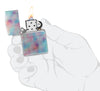 Zippo Holographic Design 540 Fusion Windproof Lighter lit in hand.