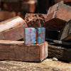 Lifestyle image of two Zippo Holographic Design 540 Fusion Windproof Lighters standing on a brick.