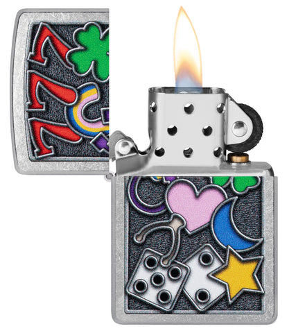 Zippo All Luck Design Street Chrome Windproof Lighter with its lid open and lit.