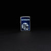 Lifestyle image of NFL Dallas Cowboys Helmet Street Chrome Windproof Lighter standing in a black background.