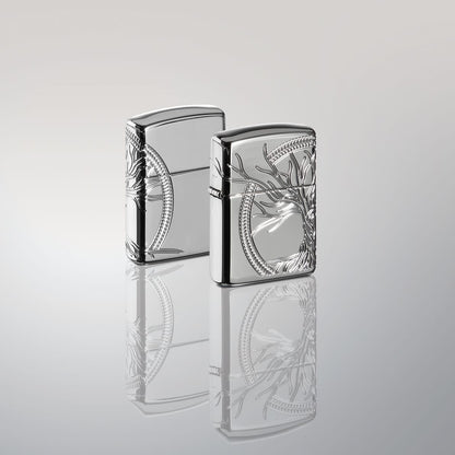 Lifestyle image of two ArmorÂ® High Polish Sterling Silver Tree of Life Windproof Lighters standing in a silver mirror scene. One lighter is showing the front of the design with the other showing the back.
