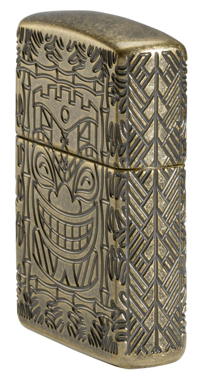 Tiki Design ArmorÂ® Antique Brass Windproof Lighter standing at an angle, showing the front and right side of the lighter.