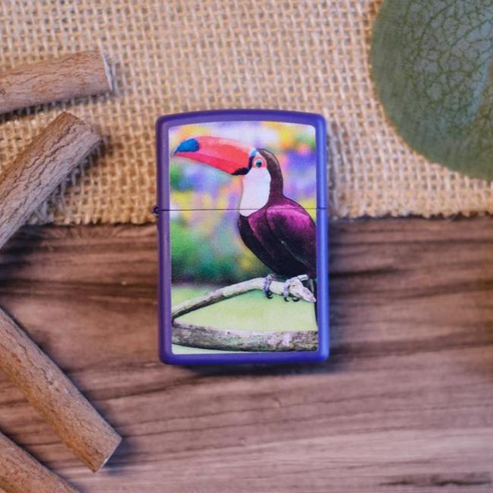 Lifestyle image of Toucan Design Purple Matte Windproof lighter laying on a table