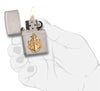 United States Navy Brass Emblem Windproof Lighter lit in hand.