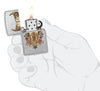 Zippo Rick Rietveld Floral Bull Skull Street Chrome Windproof Lighter lit in hand.