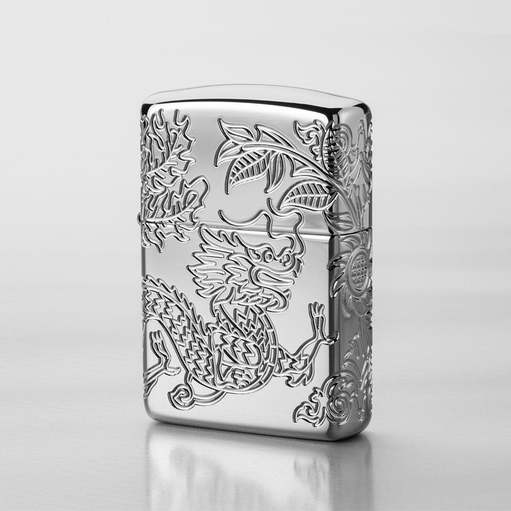 Lifestyle image of Armor® Dragon and Phoenix Design Windproof Lighter with a grey background
