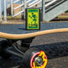 Lifestyle image of Creature Skeleton Black Matte Windproof Lighter standing on a skateboard.