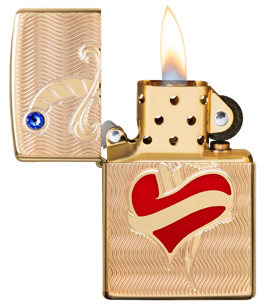 Heart and Sword Design High Polish Brass Windproof Lighter with its lid open and lit